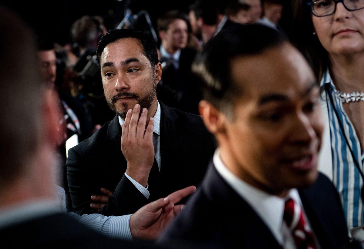 Rep. Joaquin Castro (D-Texas), left, listens to his brother Julian Castro speak to reporters after the second round of the second Democratic primary debate of the 2020 presidential campaign season hosted by CNN at the Fox Theatre in Detroit, Michigan on July 31, 2019. (Brendan SmialowskiAFP/Getty Images)