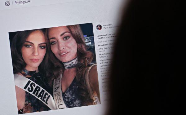 The image of a screen showing the photograph posted by the Instagram profile of Sarah Idan on Nov. 14 2017, as she is seen taking a "selfie" photograph with Adar Gandelsman, who holds the title of "Miss Universe Israel 2017", with a caption reading: "Peace and Love from Miss Iraq and Miss Israel. (Thomas CoexAFP/Getty Images)