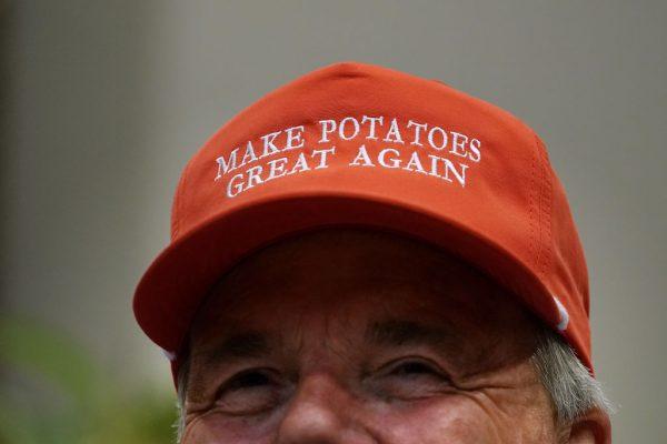 Dan Moss, of the National Potato Council, dons his 'Make Potatoes Great Again' hat before joining U.S. President Donald Trump in the Roosevelt Room at the White House in Washington on May 23, 2019. (Chip Somodevilla/Getty Images)