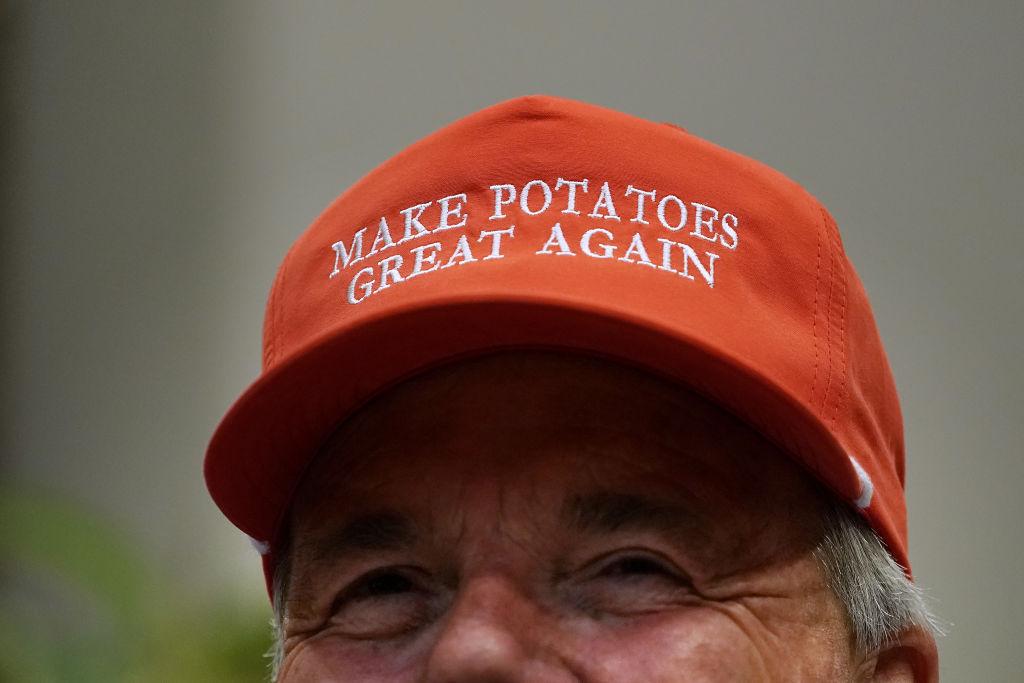 Dan Moss, of the National Potato Council, dons his 'Make Potatoes Great Again' hat before joining President Donald Trump in the Roosevelt Room at the White House in Washington, D.C. on May 23, 2019. (Chip Somodevilla/Getty Images)