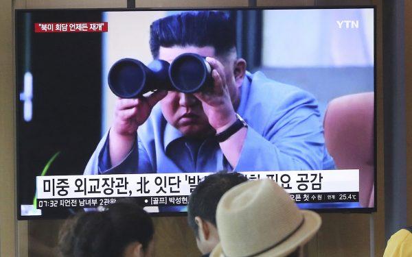 People watch a TV showing file footage of North Korean leader Kim Jong Un during a news program at the Seoul Railway Station in Seoul, South Korea, on Aug. 2, 2019. (Ahn Young-joon/AP Photo)