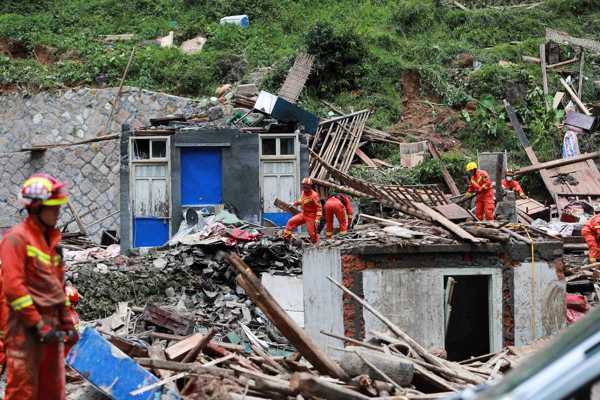 Firefighters search for survivors in collapsed houses damaged by a landslide after Typhoon Lekima hit Shanzao village in Yongjia County, Wenzhou, Zhejiang Province, China on Aug. 11, 2019. (Reuters)