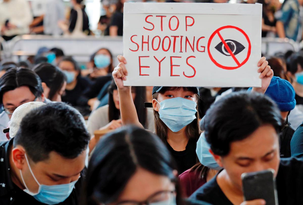 Anti-extradition bill protesters attend a mass demonstration after a woman was shot in the eye during a protest at Hong Kong International Airport, in Hong Kong, China on Aug. 12, 2019. (Tyrone Siu/Reuters)