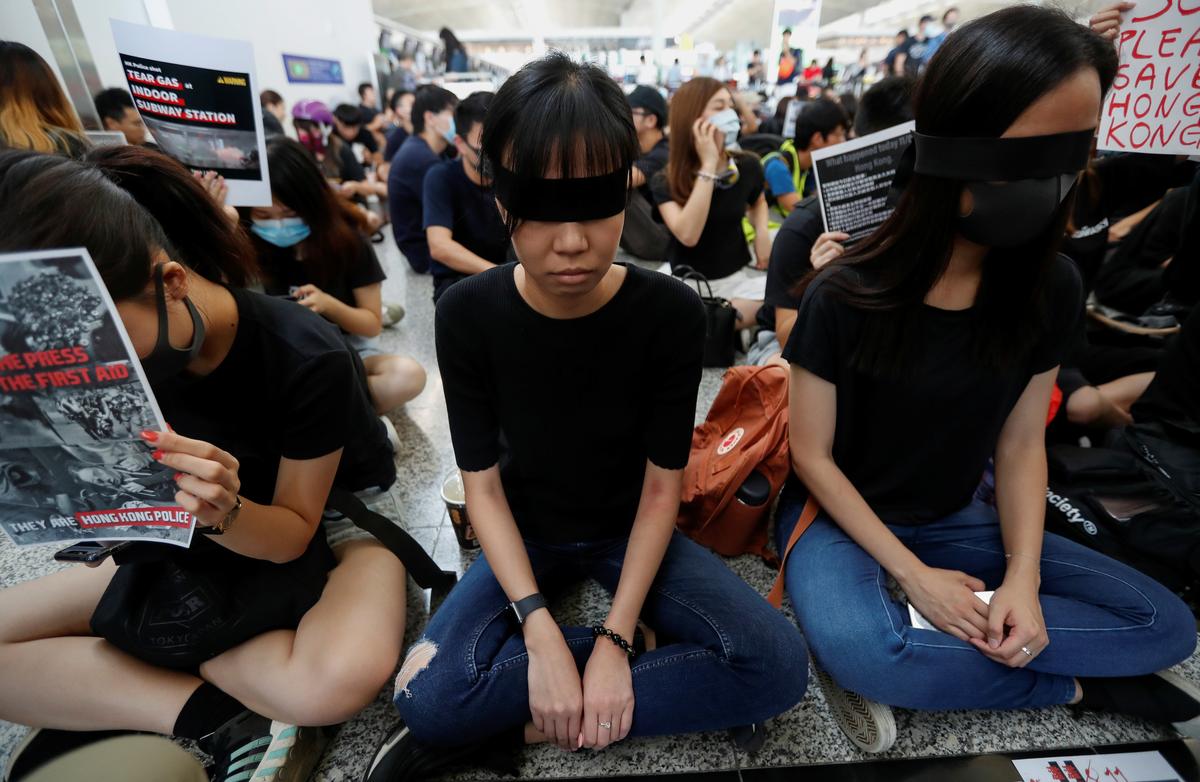 Anti-extradition bill demonstrators attend a protest at the departure hall of Hong Kong Airport, China on Aug.t 12, 2019. (Issei Kato/Reuters)
