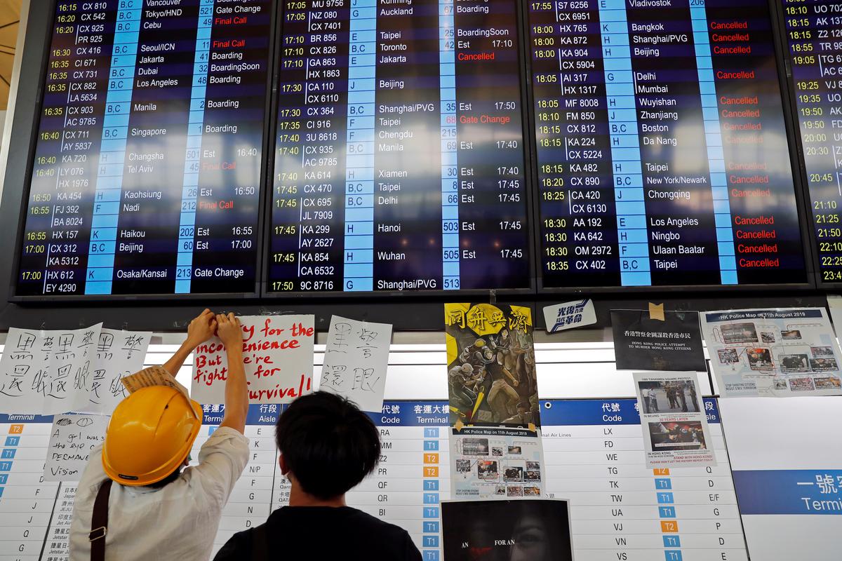 An information screen showing cancelled flights is pictured at Hong Kong International Airport as anti-extradition bill protesters attend a mass demonstration after a woman was shot in the eye during a protest in Hong Kong, China on Aug. 12, 2019. (Tyrone Siu/Reuters)
