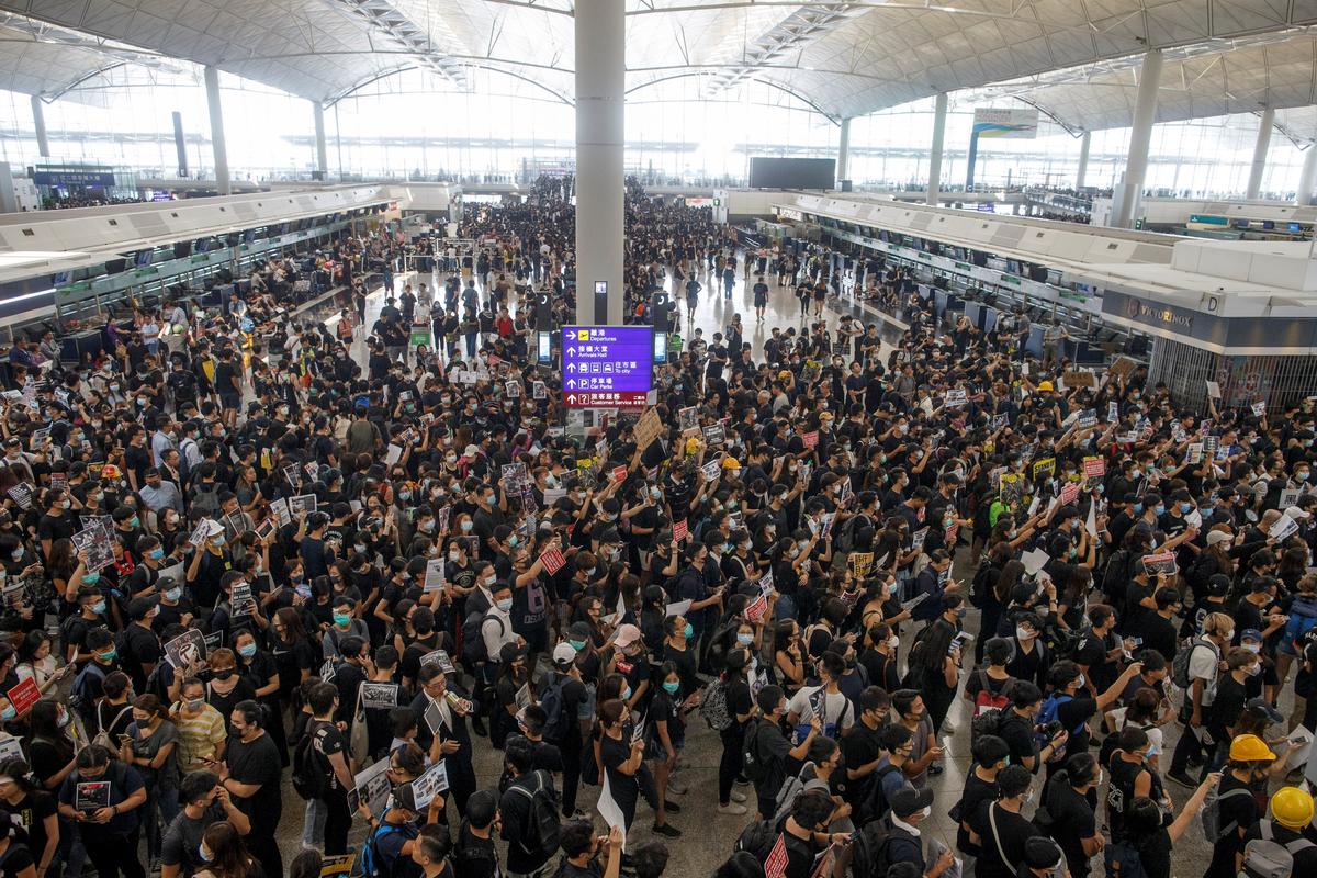 Anti-extradition bill protesters rally at the departure hall of Hong Kong airport in Hong Kong, China on Aug. 12, 2019. (Thomas Peter/Reuters)