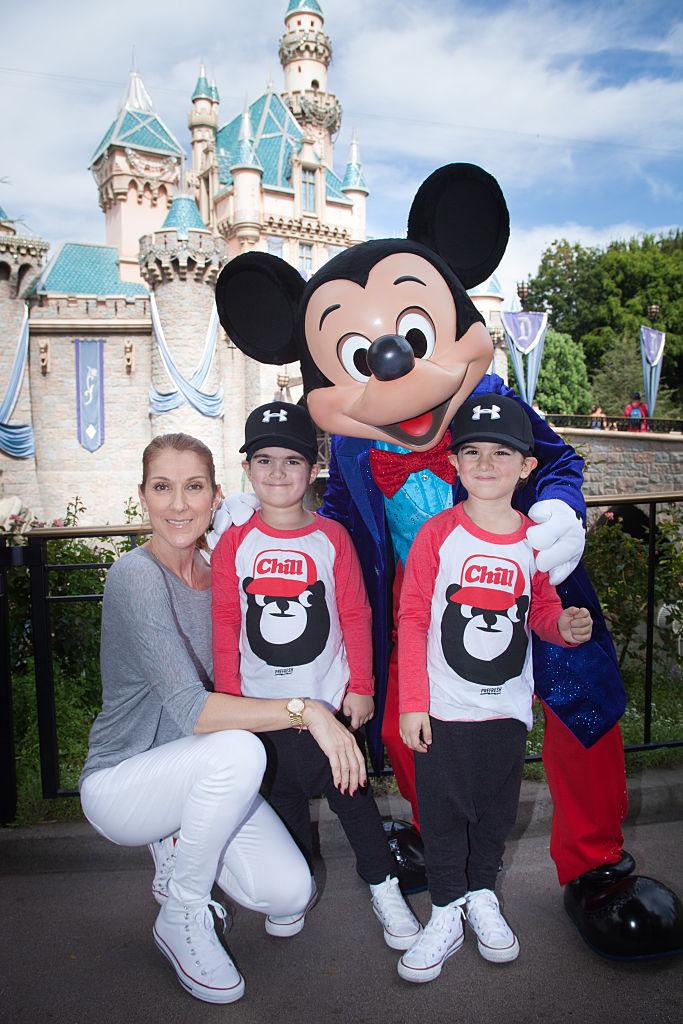 Céline Dion and her twin sons Eddy (L) and Nelson (R), aged 4, with Mickey Mouse at Disneyland in 2016 (©Getty Images | <a href="https://www.gettyimages.com.au/detail/news-photo/in-this-handout-image-provided-by-disneyland-resort-celine-news-photo/492682732">Scott Brinegar</a>)