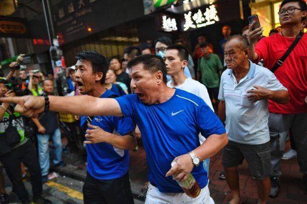 A group of pro-Beijing supporters lunges towards the media at North Point in Hong Kong on Aug. 11, 2019. (Manan Vatsyayana/AFP/Getty Images)