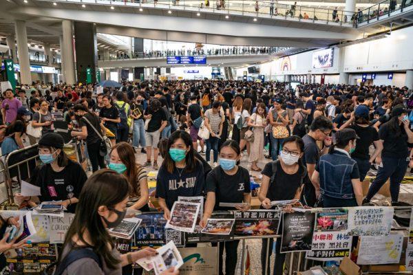 Protesters hand out leaflets at the arrival hall of the Hong Kong International Airport during a demonstration on Aug. 11, 2019. (Anthony Kwan/Getty Images)