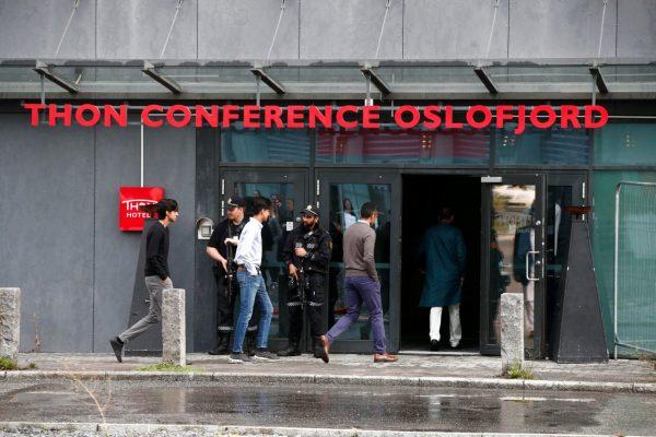 Armed police officers stand guard as Muslims from the Al-Noor mosque in Baerum arrive at the Thon hotel to attend the prayers during the first day of Eid al-Adha, in Oslo, Norway, on Aug. 11, 2019. (Terje Pedersen/NTB Scanpix/via Reuters)