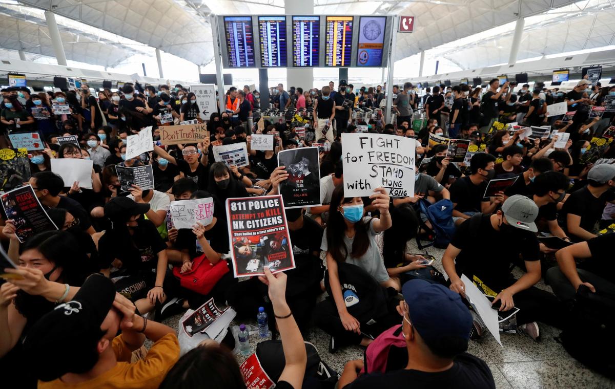 Anti-extradition bill demonstrators attend a protest at the departure hall of Hong Kong Airport, on Aug. 12, 2019. (Issei Kato/Reuters)