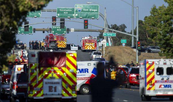 Authorities work the scene where a shootout near a freeway killed a California Highway Patrol officer and wounded two others before the gunman was fatally shot, in Riverside, Calif. on Aug. 12, 2019,  (Terry Pierson/The Orange County Register via AP)