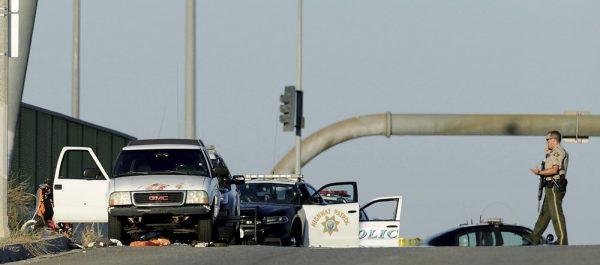 Authorities investigate the scene on the Eastridge Avenue overpass over Interstate 215, where a fatal shootout occurred, in Riverside, Calif. on Aug. 12, 2019. (Terry Pierson/The Orange County Register via AP)