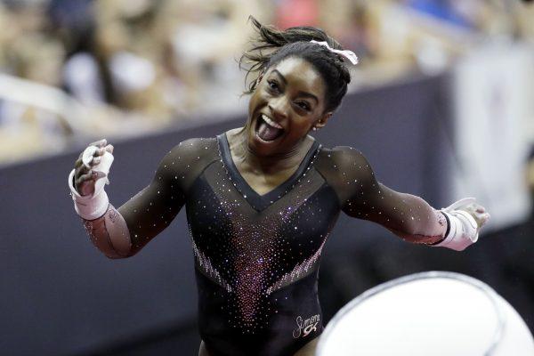 Simone Biles celebrates after competing in the uneven bars to win the all around senior women's competition at the 2019 U.S. Gymnastics Championships on Aug. 11, 2019, in Kansas City, Mo. (Charlie Riedel/AP Photo)