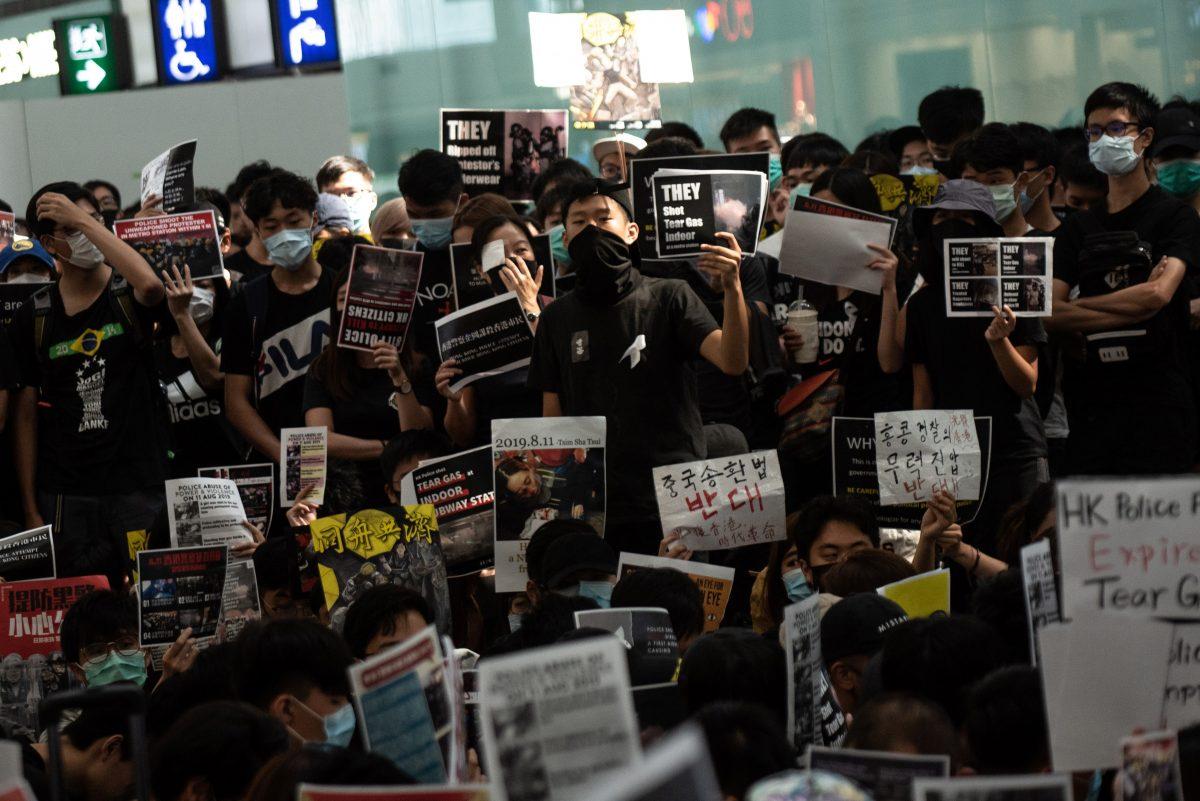 A group of pro-democracy protesters chant slogans outside the departures hall during another demonstration at Hong Kong's international airport on Aug. 13, 2019. (Philip Fong/AFP/Getty Images)
