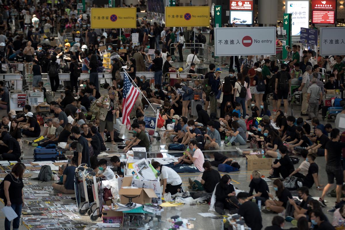 Protesters stage a sit-in rally at the arrival hall of the Hong Kong International Airport in Hong Kong, China on Aug. 13, 2019. (Vincent Thian/AP)