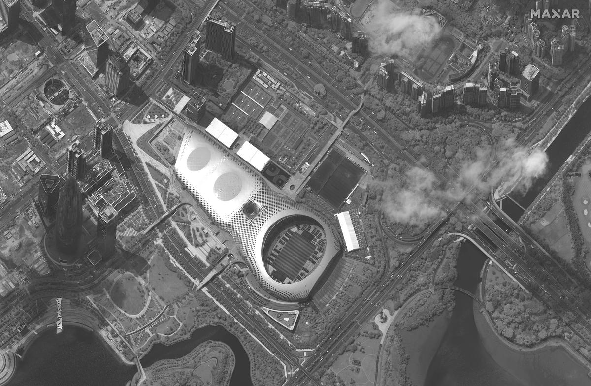 This satellite image shows Chinese security force vehicles inside the Shenzen Bay Sports Center, middle, in the southern Chinese city of Shenzhen, bordering Hong Kong on Aug. 12, 2019. (Satellite image ©2019 Maxar Technologies via AP)