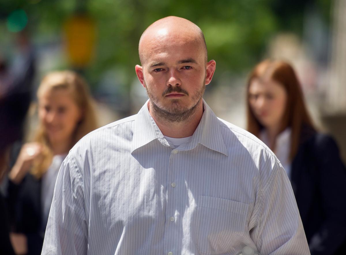 Former Blackwater Worldwide guard Nicholas Slatten enters a taxi cab as he leaves federal court in Washington, after the start of his trial on June 11, 2014. (AP Photo/Cliff Owen, File)