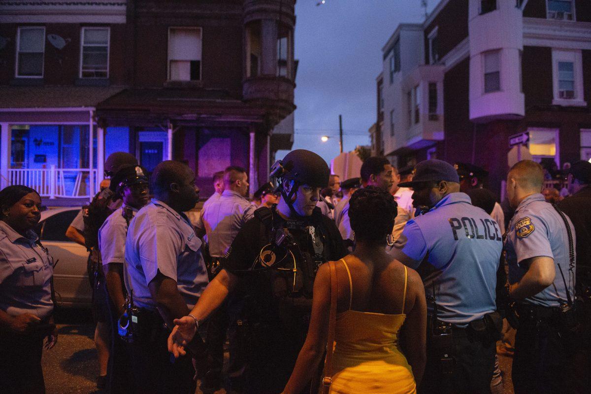 Police officers gather for crowd control as a shooting is investigated, in Philadelphia, Aug. 14, 2019. (Joe Lamberti/Camden Courier-Post via AP)