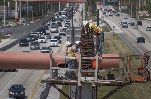 Workers on a Florida Turnpike interchange construction site in Miami on May 22, 2019. (Joe Raedle/Getty Images)