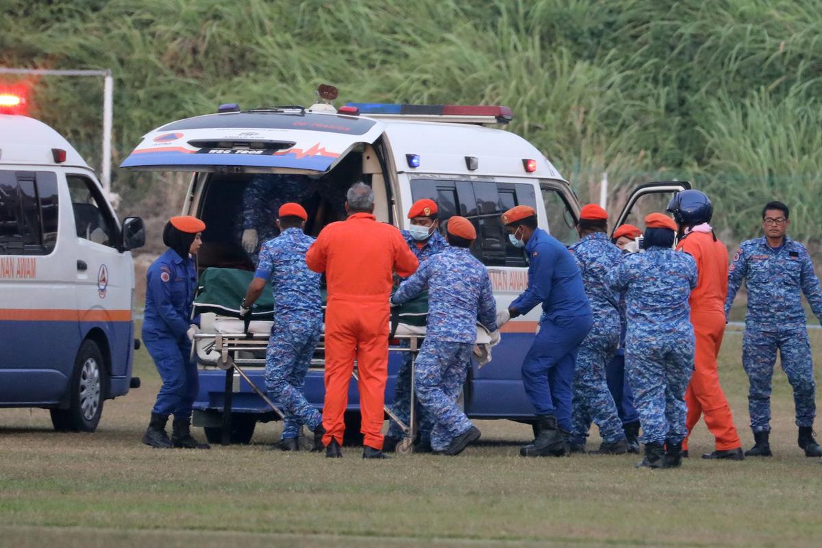A body of 15-year-old Irish girl Nora Anne Quoirin who went missing is brought into a ambulance in Seremban, Malaysia, on Aug. 13, 2019. (Reuters/Lim Huey Teng)