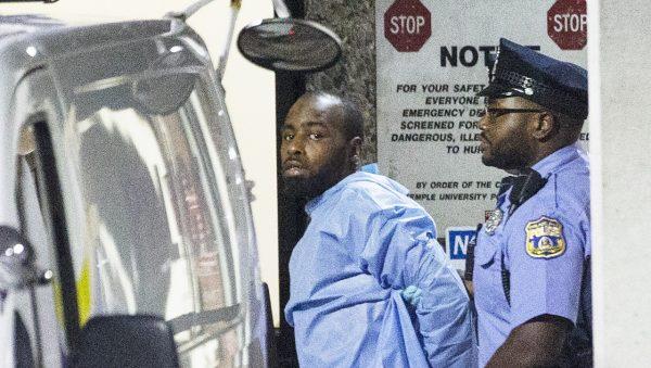 Police take shooting suspect, Maurice Hill, into custody after an hours-long standoff with police that wounded several police officers in Philadelphia, on Aug. 15, 2019. (Elizabeth Robertson/The Philadelphia Inquirer via AP)