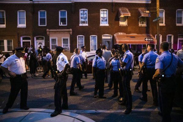 Officers gather for crowd control near a massive police presence set up outside a house as they investigate an active shooting situation in Pa. on Aug. 14, 2019. (Matt Rourke/AP)