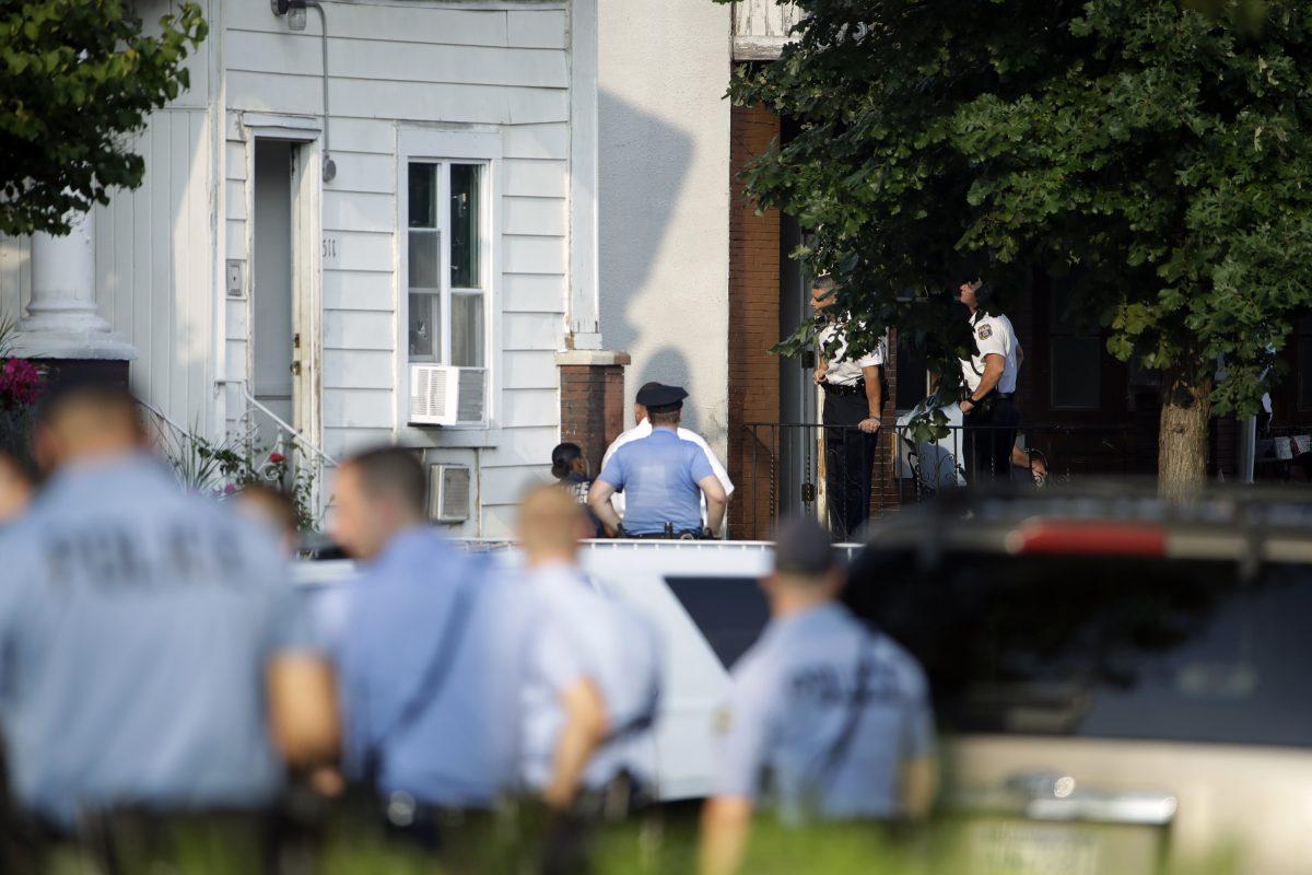 Authorities stand outside a house as they investigate an active shooting situation in the Nicetown neighborhood of Philadelphia on Aug. 14, 2019. (Matt Rourke/AP Photo)