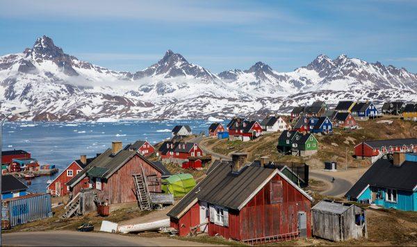 Snow-covered mountains rise above the harbor and town of Tasiilaq, Greenland, June 15, 2018. (Lucas Jackson/File Photo/Reuters)