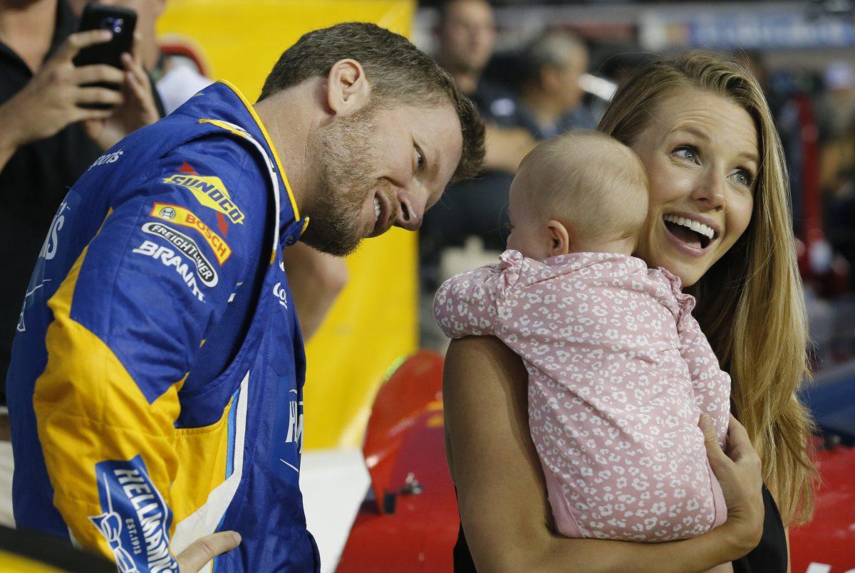 Dale Earnhardt Jr. looks at his daughter, Isla, and his wife Amy on pit row prior to an Xfinity Series NASCAR auto race at Richmond Raceway in Richmond, Va. on Sept. 21, 2018. (Steve Helber/AP Photo)