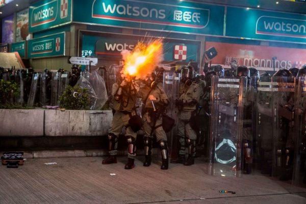 Riot police fire tear gas in the Mong Kok district of Hong Kong on Aug. 3, 2019. (Isaac Lawrence/AFP/Getty Images)