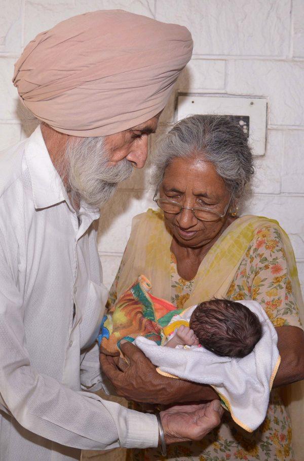 Indian father Mohinder Singh Gill, 79, and his wife Daljinder Kaur, 70, pose for a photograph as they hold their newborn baby boy Arman at their home in Amritsar on May 11, 2016.<br/>An Indian woman who gave birth at the age of 70 said May 10 she was not too old to become a first-time mother, adding that her life was now complete. Daljinder Kaur gave birth last month to a boy following two years of IVF treatment at a fertility clinic in the northern state of Haryana with her 79-year-old husband.<br/>/ AFP / NARINDER NANU (Photo credit should read NARINDER NANU/AFP/Getty Images)