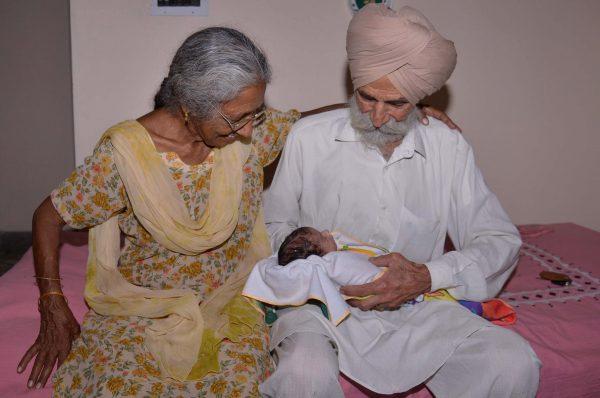 Indian father Mohinder Singh Gill, 79, and his wife Daljinder Kaur, 70, pose for a photograph as they hold their newborn baby boy Arman at their home in Amritsar on May 11, 2016.<br/>An Indian woman who gave birth at the age of 70 said May 10 she was not too old to become a first-time mother, adding that her life was now complete. Daljinder Kaur gave birth last month to a boy following two years of IVF treatment at a fertility clinic in the northern state of Haryana with her 79-year-old husband.<br/>/ AFP / NARINDER NANU (Photo credit should read NARINDER NANU/AFP/Getty Images)