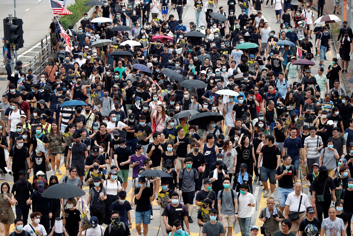 Anti-extradition bill protesters walk through Sham Shui Po neighborhood in Hong Kong, China on Aug. 11, 2019. (Issei Kato/Reuters)