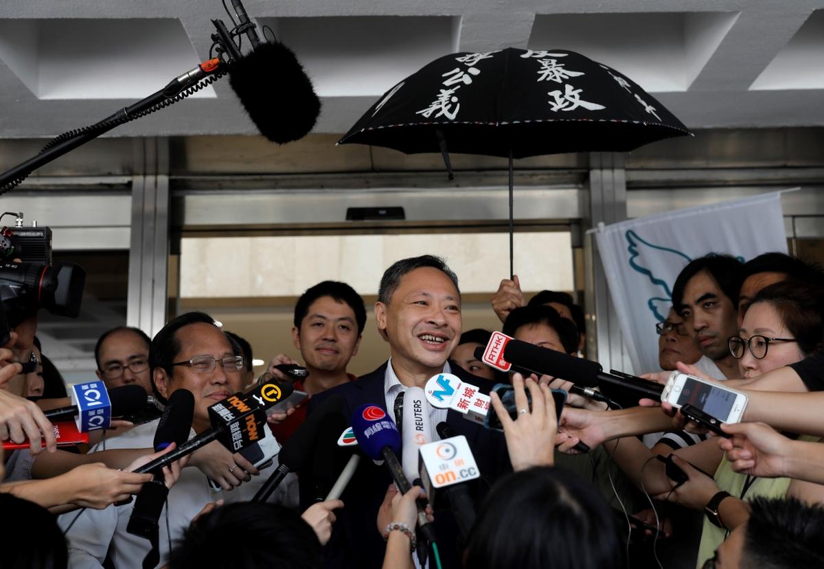 Pro-democracy activist Benny Tai (C) talks to reporters outside the High court, after being released on bail, in Hong Kong on Aug. 15, 2019. (Vincent Yu/AP Photo)