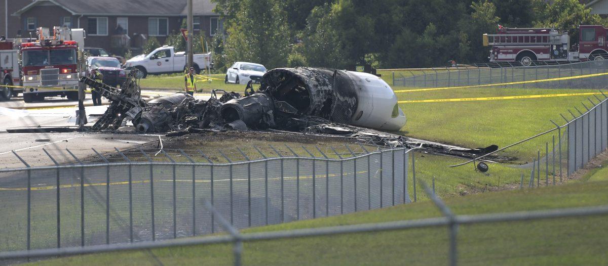 The burned remains of a plane that was carrying NASCAR television analyst and former driver Dale Earnhardt Jr. lie near a runway in Elizabethton, Tenn. on Aug. 15, 2019. (Earl Neikirk/Bristol Herald Courier via AP)
