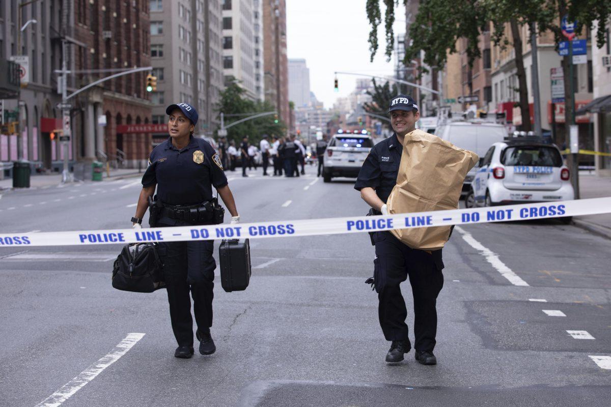 An investigator carries away a suspicious package as evidence after it was thought to be an explosive device in Manhattan's Chelsea neighborhood in New York on Aug. 16, 2019. (Kevin Hagen/AP Photo)