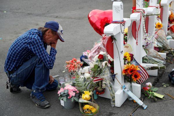 Antonio Basco cries beside a cross at a makeshift memorial near the scene of a mass shooting at a shopping complex in El Paso, Texas on Aug. 6, 2019. (John Locher/AP Photo)