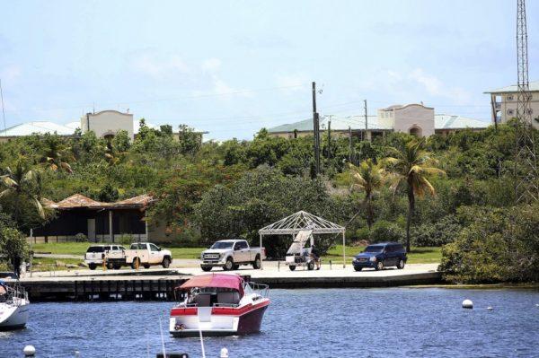 Vehicles are parked on a government dock in Red Hook where FBI agents were seen boarding a boat, in St. Thomas, U.S. Virgin Islands on Aug. 14, 2019. (Gabriel Lopez Albarran/AP Photo)