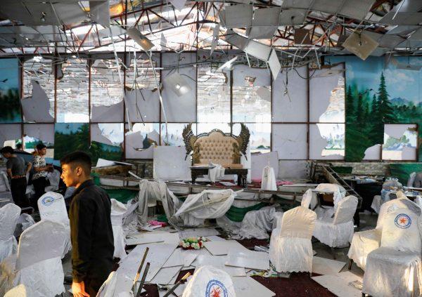 Workers at a wedding hall inspect the scene after a blast in Kabul, Afghanistan, on Aug. 18, 2019. (REUTERS/Mohammad Ismail)