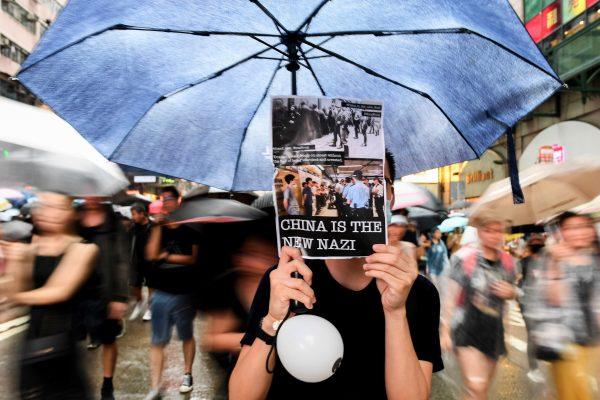 Protesters walk along a street during a rally in Hong Kong on Aug. 18, 2019, in the latest opposition to a planned extradition law that has since transformed into a wider call for democratic rights. (Manan Vatsyana/AFP/Getty Images)