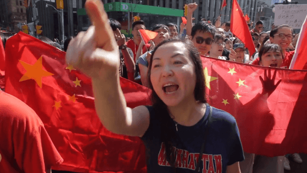 A pro-Beijing demonstrator points and chants slogans at Hong Kong supporters during a rally in Toronto on Aug. 17, 2019. (Arek Rusek/NTD Television)