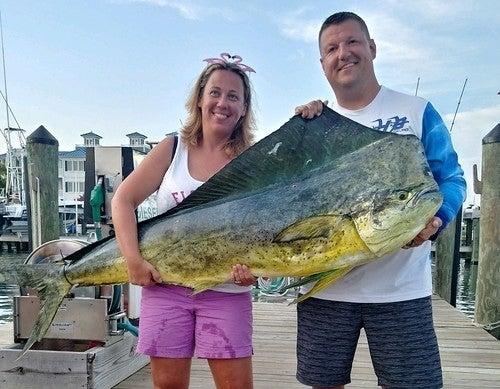 Kristi Frashure poses with her husband, Ryan, and the record-setting common dolphinfish she caught off Ocean City on Aug. 16, 2019. (Maryland Department of Natural Resources)