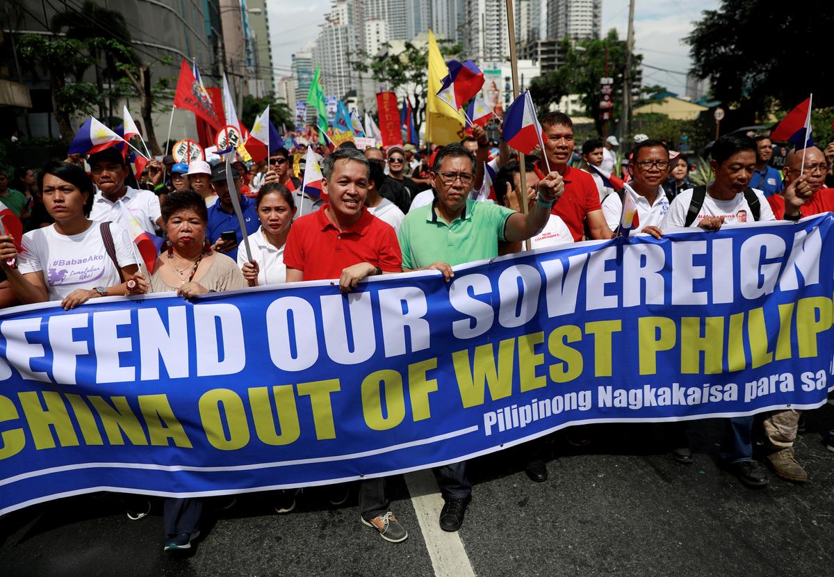 Filipino activists and opposition leaders march to protest the presence of Chinese vessels in South China Sea at the Chinese Embassy in Makati City, Philippines on April 9, 2019. (Eloisa Lopez/Reuters)