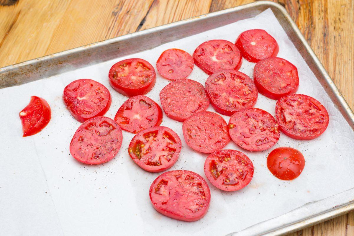 Salt the tomatoes first, to remove excess liquid and avoid a soggy crust. (Caroline Chambers)