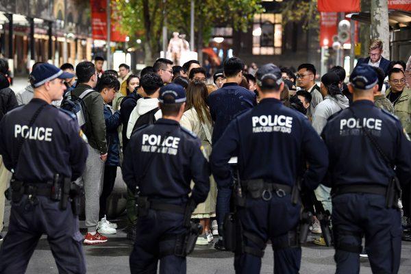 Australian police stand guard as supporters of Hong Kong pro-democracy protesters and pro-China supporters separate during a demonstration at Martin Place in Sydney, Australia, on Aug. 16, 2019. (Saeed Khan/AFP/Getty Images)