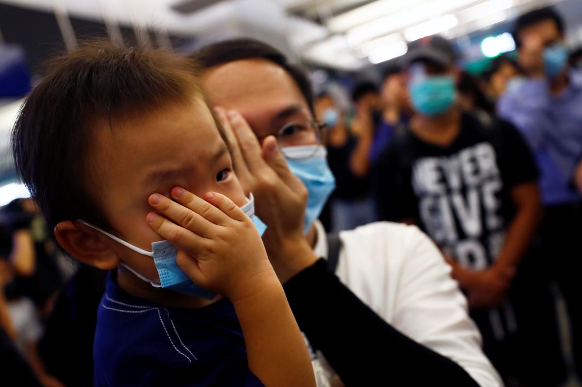 People protest during a silent sit-in gathering at Yuen Long MTR station in Hong Kong, China on Aug. 21, 2019. (Kai Pfaffenbach/Reuters)