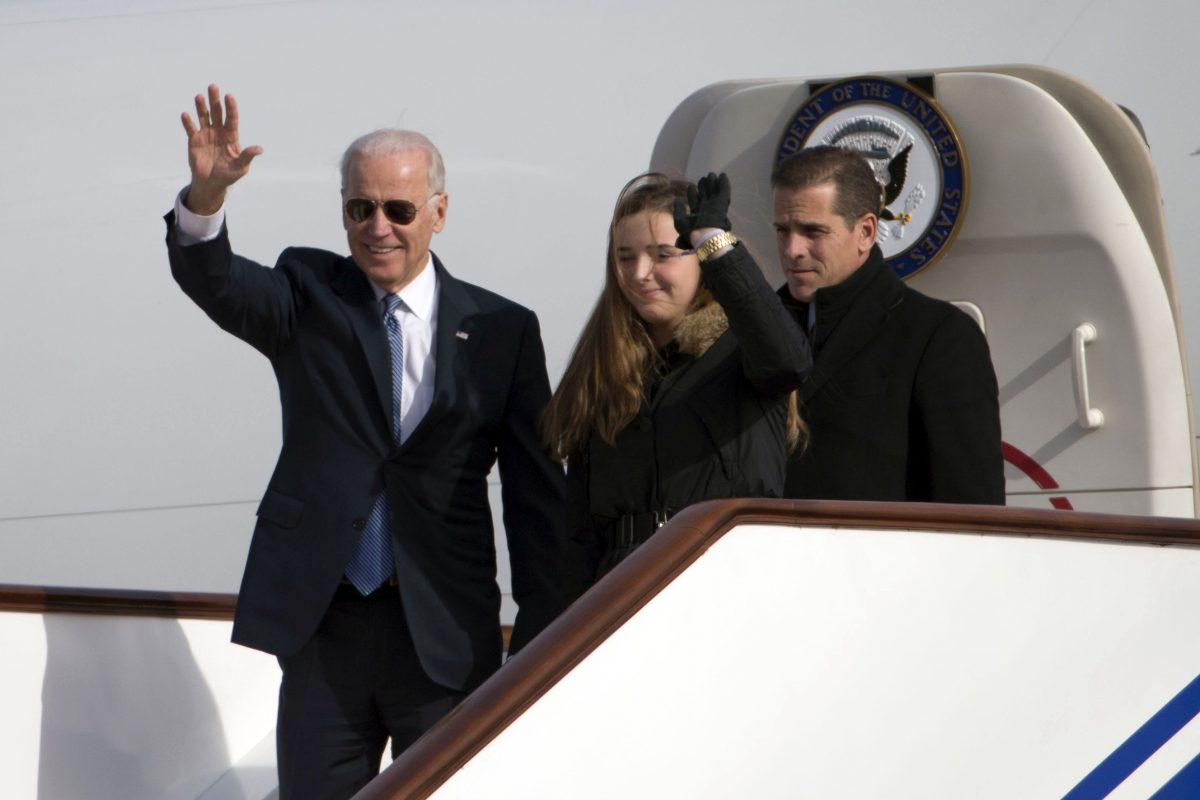 Then-Vice President Joe Biden waves as he walks out of Air Force Two with his granddaughter Finnegan Biden (C) and son Hunter Biden (R) at the airport in Beijing on Dec. 4, 2013. (Ng Han Guan-Pool/Getty Images)