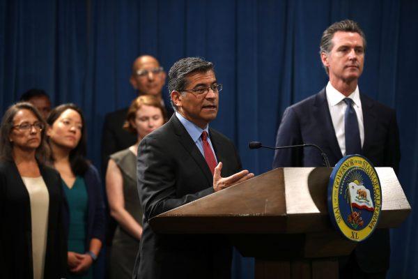  California attorney General Xavier Becerra (C) speaks during a news conference with California Gov. Gavin Newsom (R) at the California State Capitol in Sacramento, Calif., on Aug. 16, 2019. (Justin Sullivan/Getty Images)