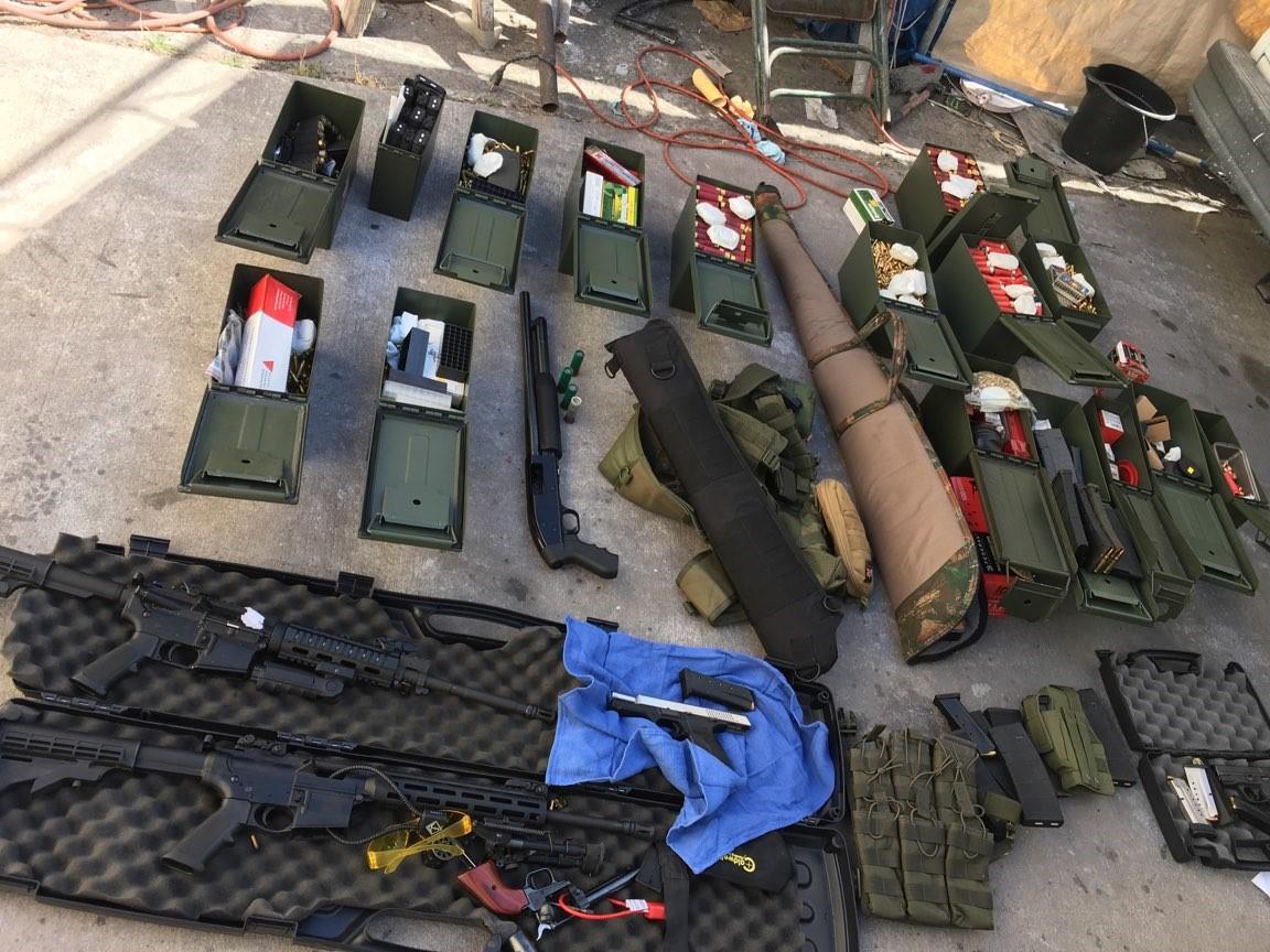 Guns, magazines, and ammunition were among the items found in a search of Rondolfo Montoya's residence, police said. (Long Beach Police Department)